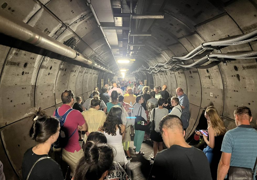 Handout photo taken with permission from the Twitter feed of Kate Scott of passengers in an emergency tunnel as Eurotunnel passengers are facing travel chaos after a train broke down down beneath the English Channel. Issue date: Tuesday August 23, 2022.