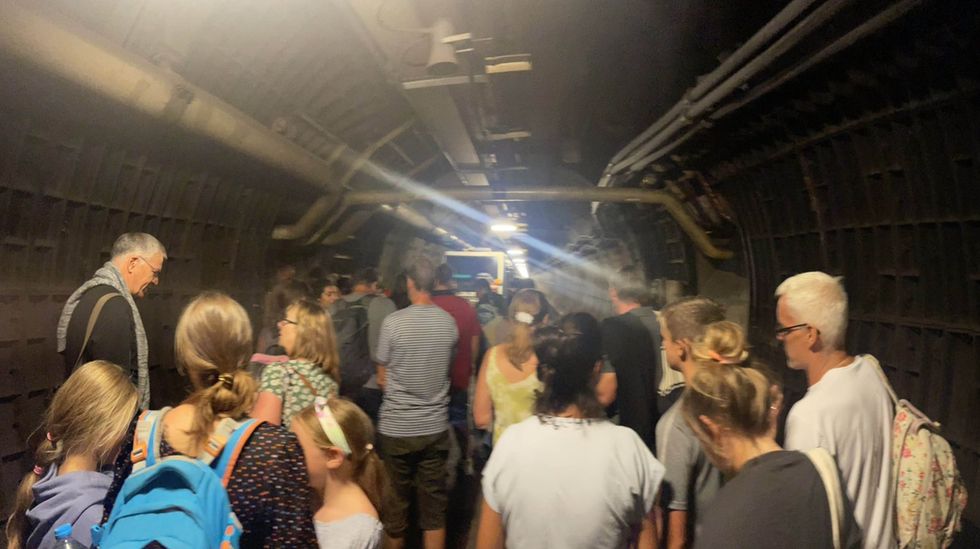 Handout photo taken with permission from the Twitter feed of SJF Dudsy of passengers in an emergency tunnel as Eurotunnel passengers are facing travel chaos after a train broke down down beneath the English Channel. Issue date: Tuesday August 23, 2022.