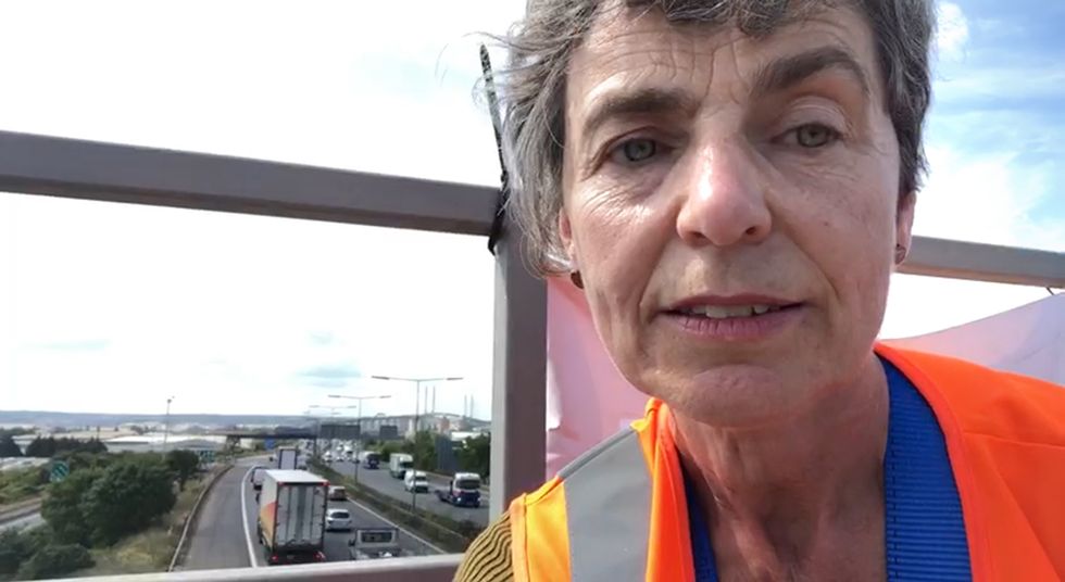 Handout screen grab taken from a video issued by Just Stop Oil of one of their activists who has climbed a motorway sign on the M25 at Dartford between Queen Elizabeth Bridge northbound and J30 in response to the extreme temperatures in the UK and what they describe as the Government's %22inadequate preparations%22 for climate change. Issue date: Wednesday July 20, 2022.