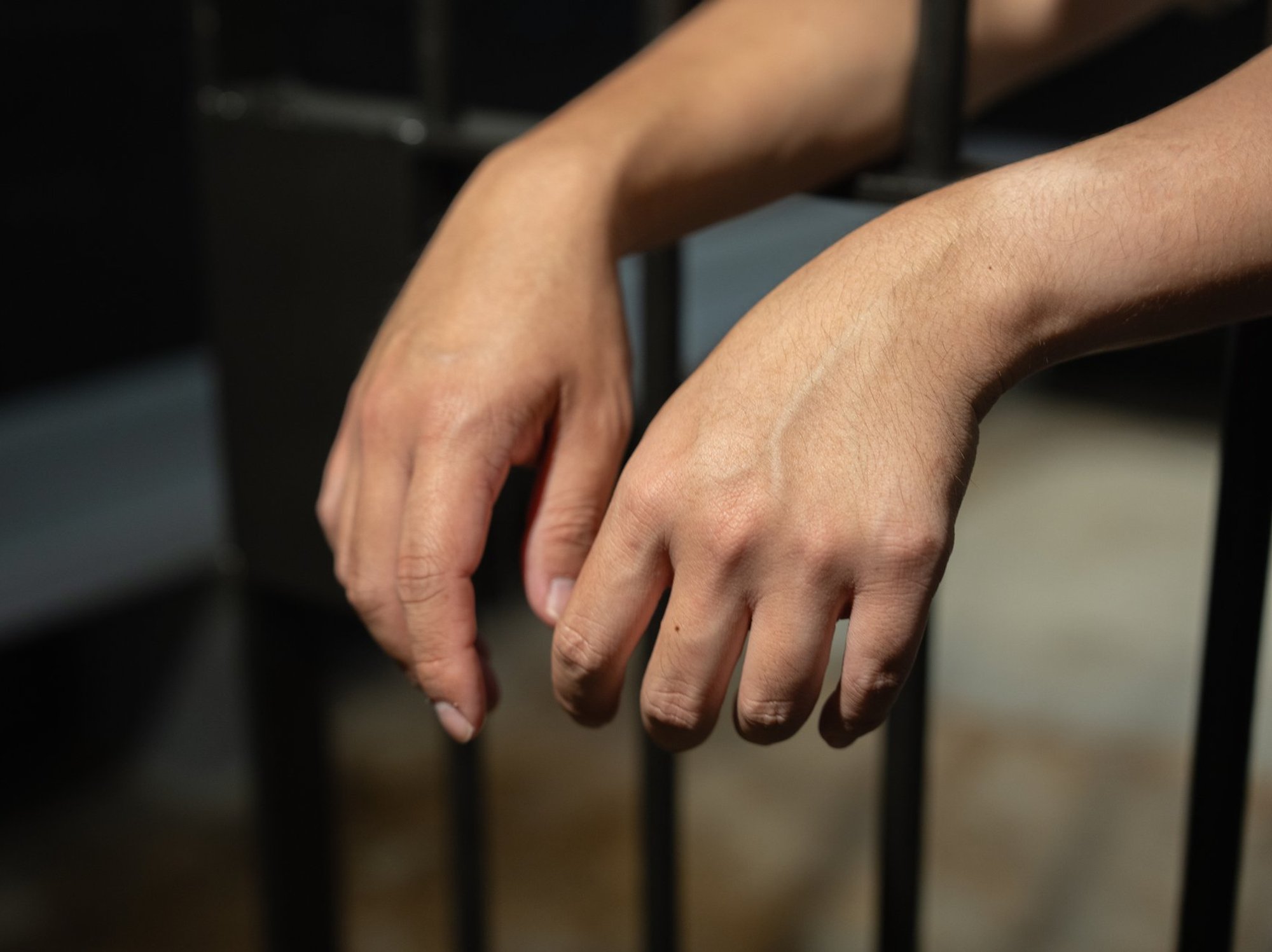 hands behind bars