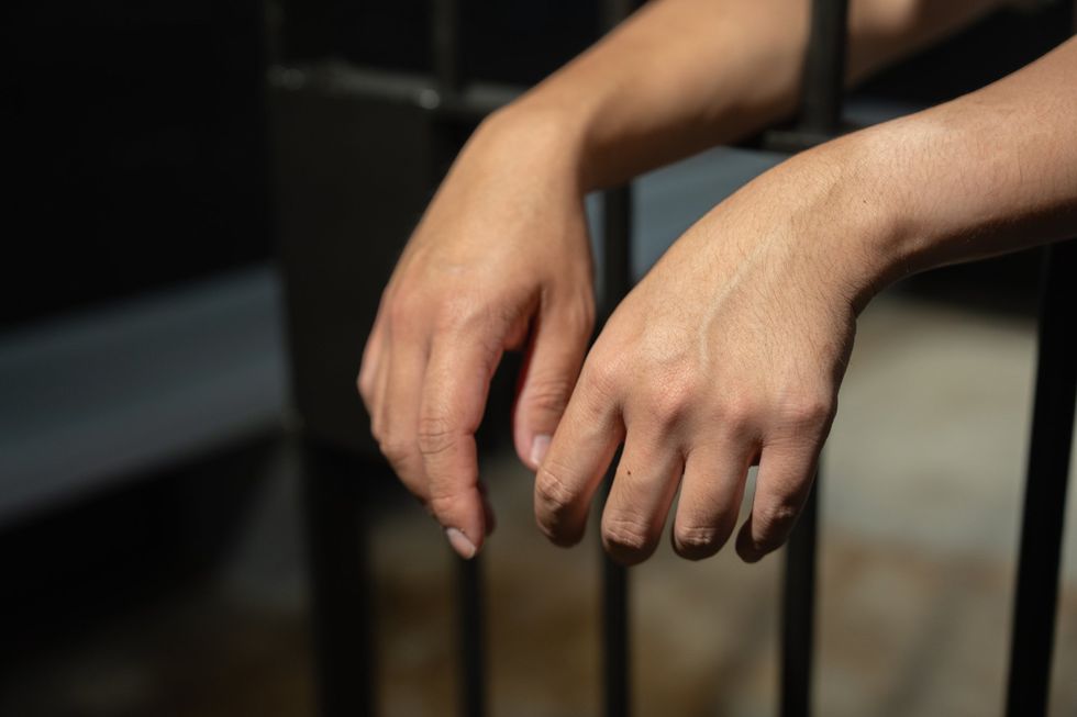 hands behind bars