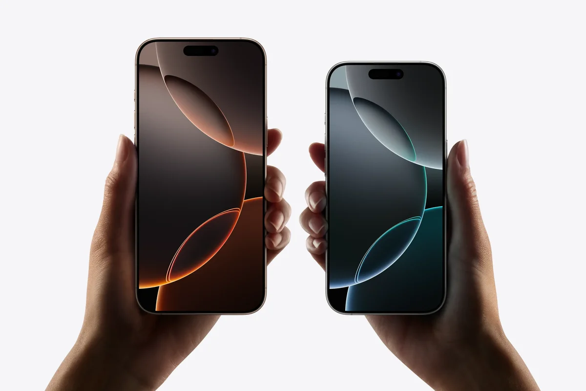 hands holding the iphone 16 pro and iphone 16 pro max