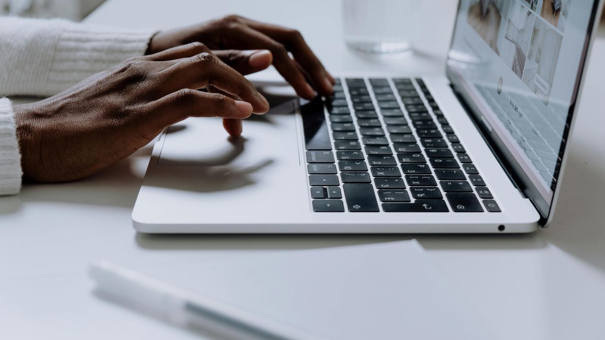 Hands typing on Apple MacBook