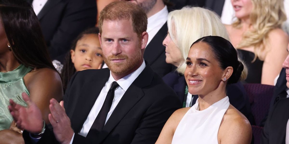 Prince Harry accepts award despite tens of thousands signing petition to stop him as Meghan Markle watches on