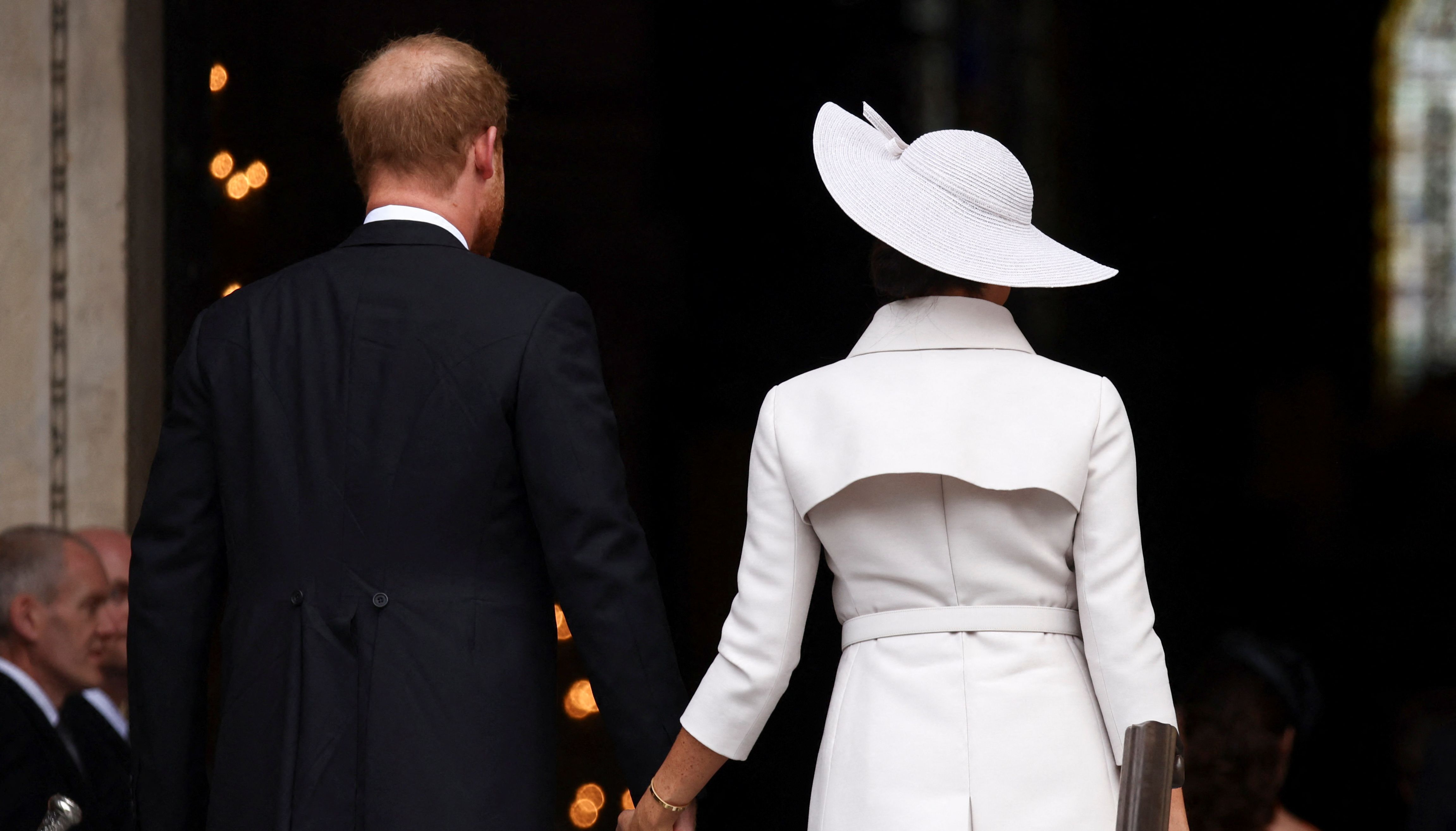Harry and Meghan hold hands and enter the Cathedral