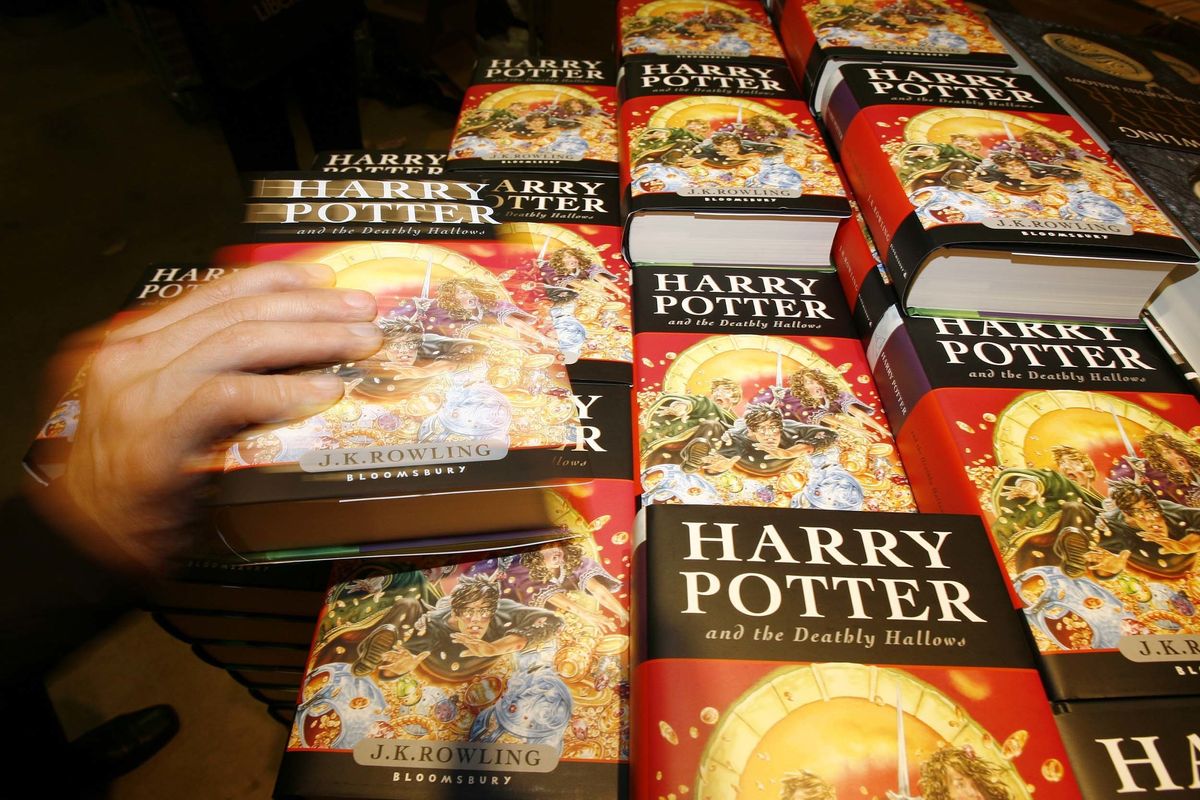 Harry Potter fans grab copys of the new and final Harry Potter book 'The Deathly Hallows' which went on sale at midnight at W H Smith Kings Cross in London
