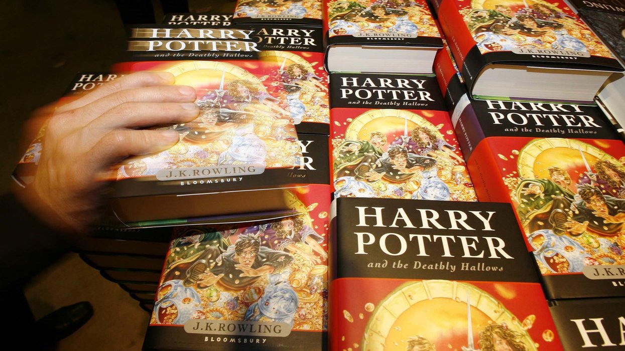 Harry Potter fans grab copys of the new and final Harry Potter book 'The Deathly Hallows' which went on sale at midnight at W H Smith Kings Cross in London