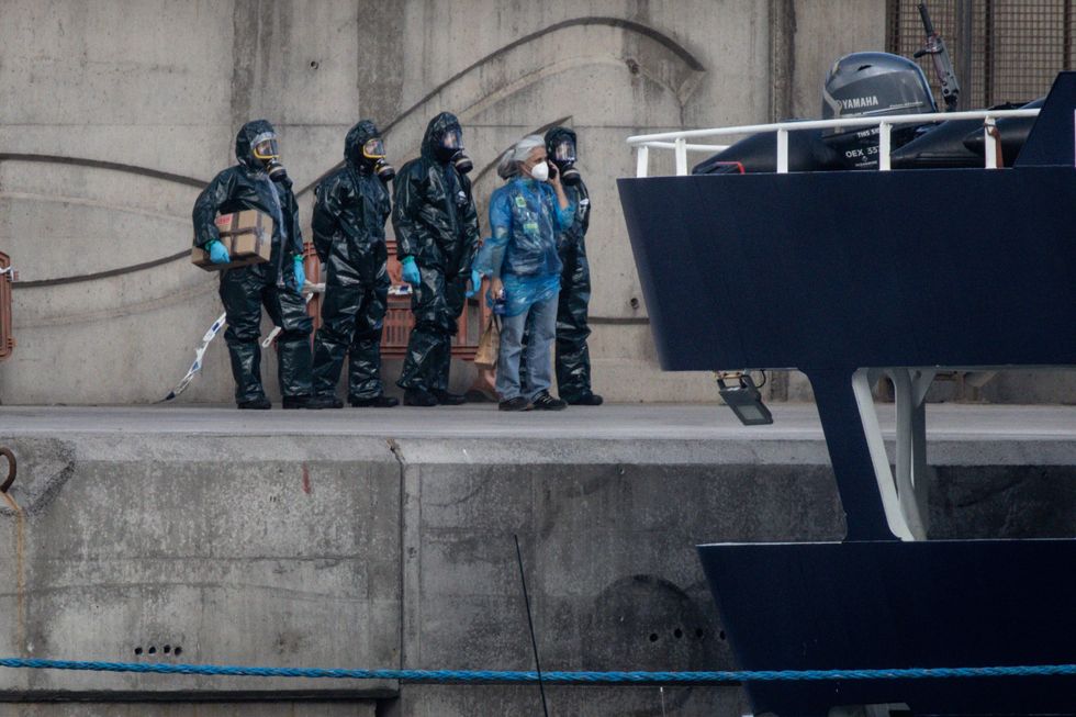 Hazmat suit crew by the MV Hondius