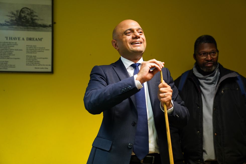 Health Secretary Sajid Javid plays a game of pool during a visit to the African Caribbean Community Initiative (ACCI) in Wolverhampton