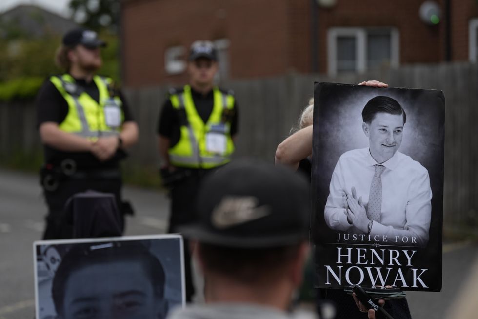 Henry Nowak demonstration with police in the background