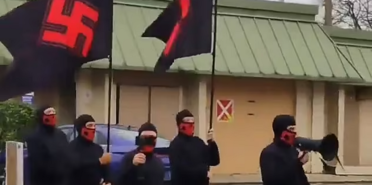 NextImg:Masked neo-Nazis carrying SWASTIKA flags march brazenly through major US city in shocking display