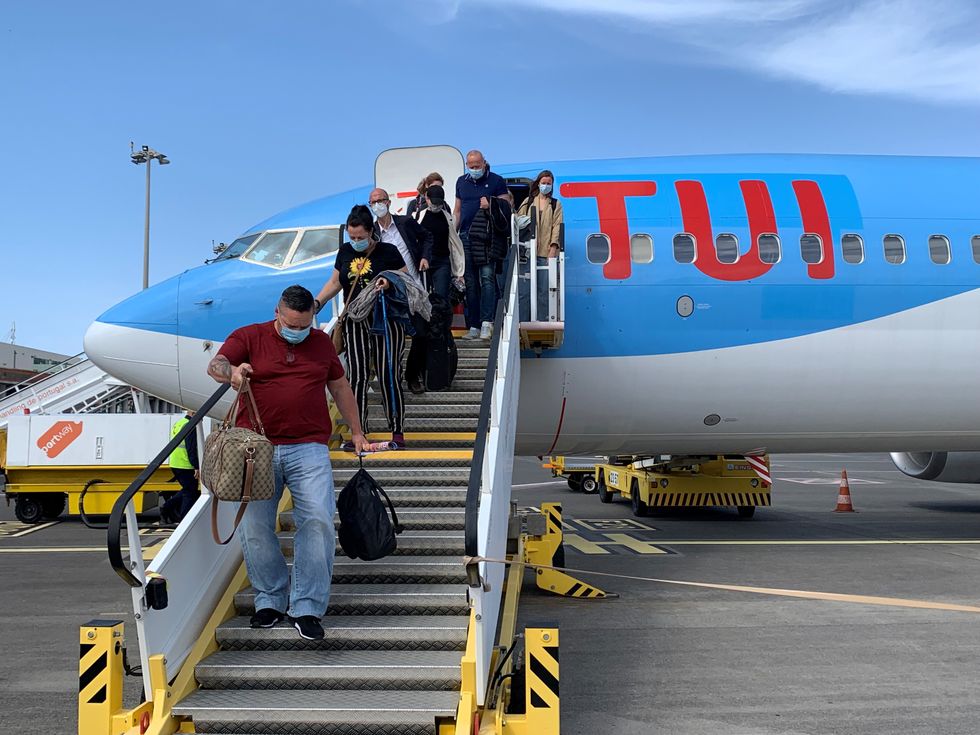 Holidaymakers disembarking from their London Gatwick flight in Madeira this morning. Thousands of people have departed on international flights after the ban on foreign holidays was lifted for people in Britain. Picture date: Monday May 17, 2021.