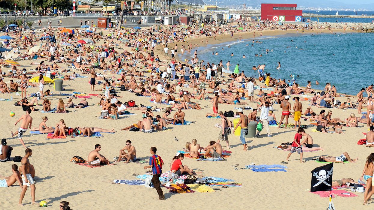 Holidaymakers on a beach in Spain