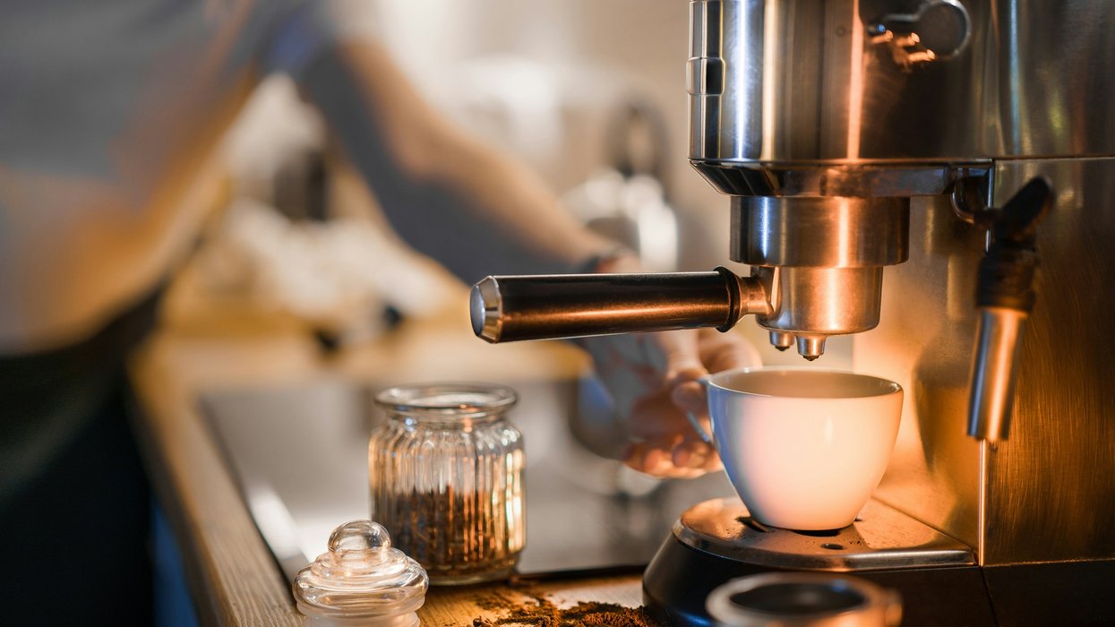 Home coffee machine brewing a cup of coffee