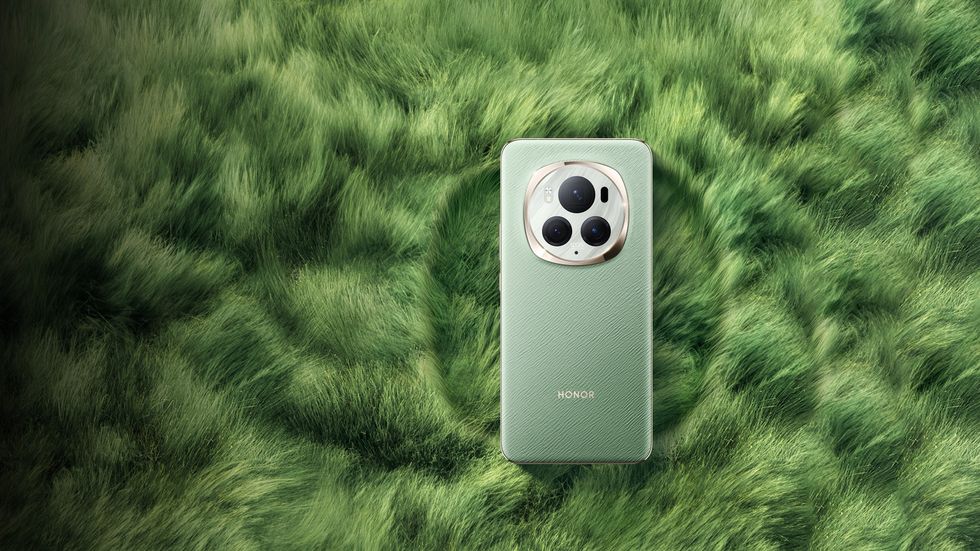 honor magic 6 pro pictured in green lying on grass