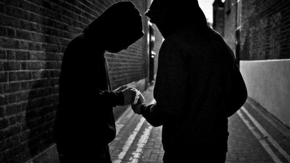 Hooded children dealing drugs