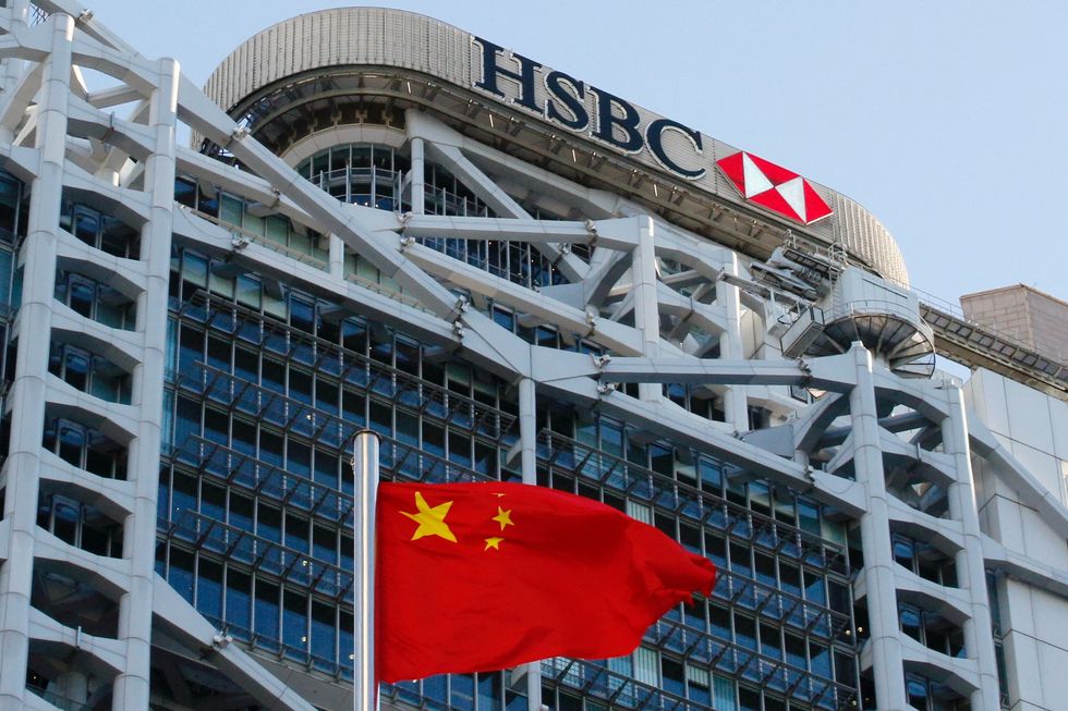 HSBC HQ in Hong Kong, with the Chinese flag blowing in the wind below it