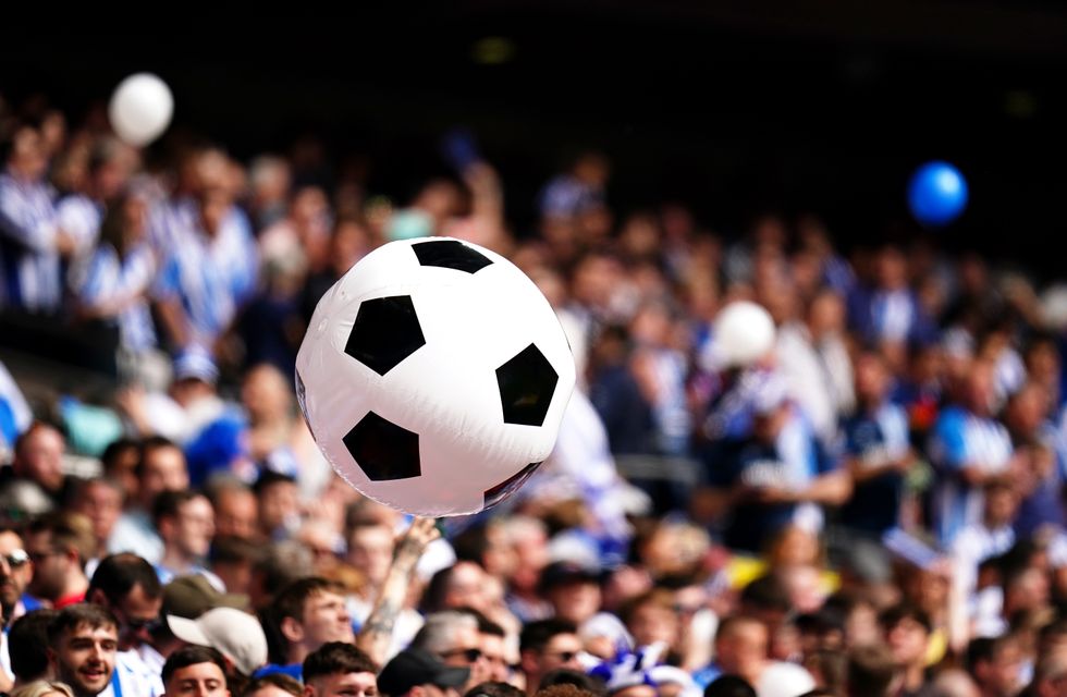 Huddersfield Town fans pass an inflatable ball around prior to kick-off in the Sky Bet Championship play-off final at Wembley Stadium, London. Picture date: Sunday May 29, 2022.