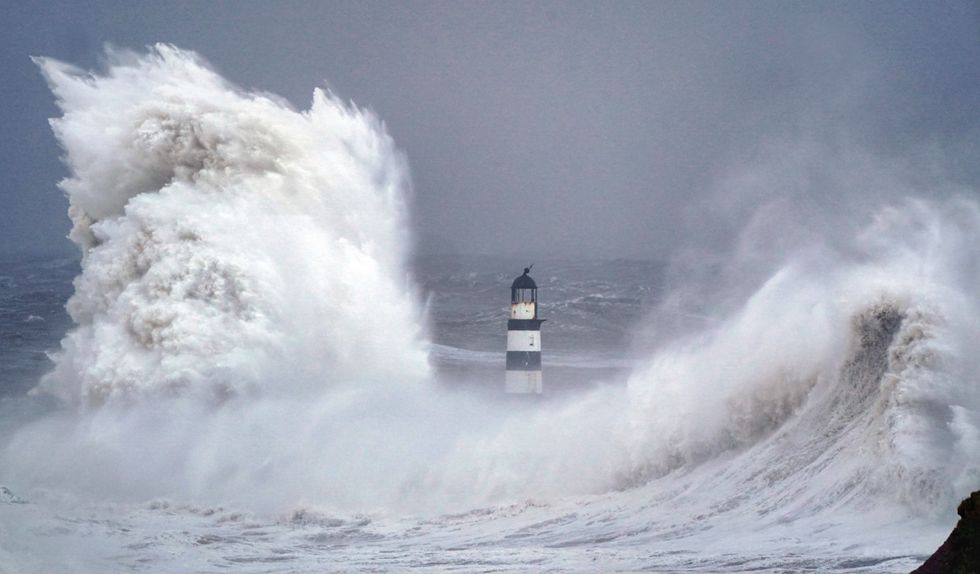 Huge waves crash against the lighthouse in Seaham Harbour, County Durham
