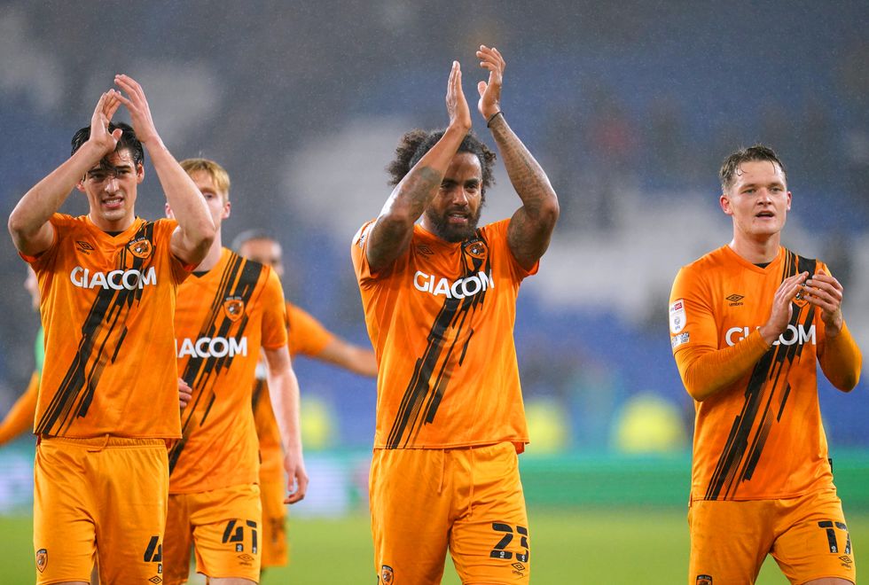 Hull City's Tom Huddlestone (centre) applauds the fans at the end of the Sky Bet Championship match at the Cardiff City Stadium. Picture date: Wednesday November 24, 2021.