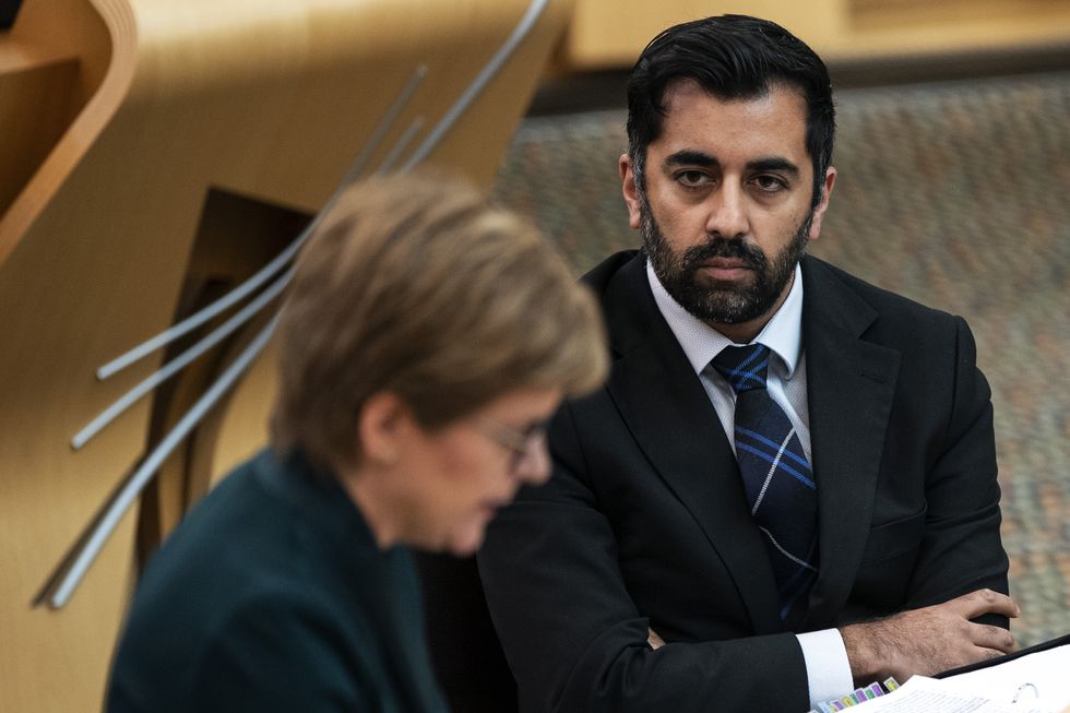 Humza Yousaf, Cabinet Secretary for Health and Social Care listens to Scotland's First Minister Nicola Sturgeon during First Minster's Questions at the Scottish Parliament in Holyrood, Edinburgh. Picture date: Thursday September 16, 2021.
