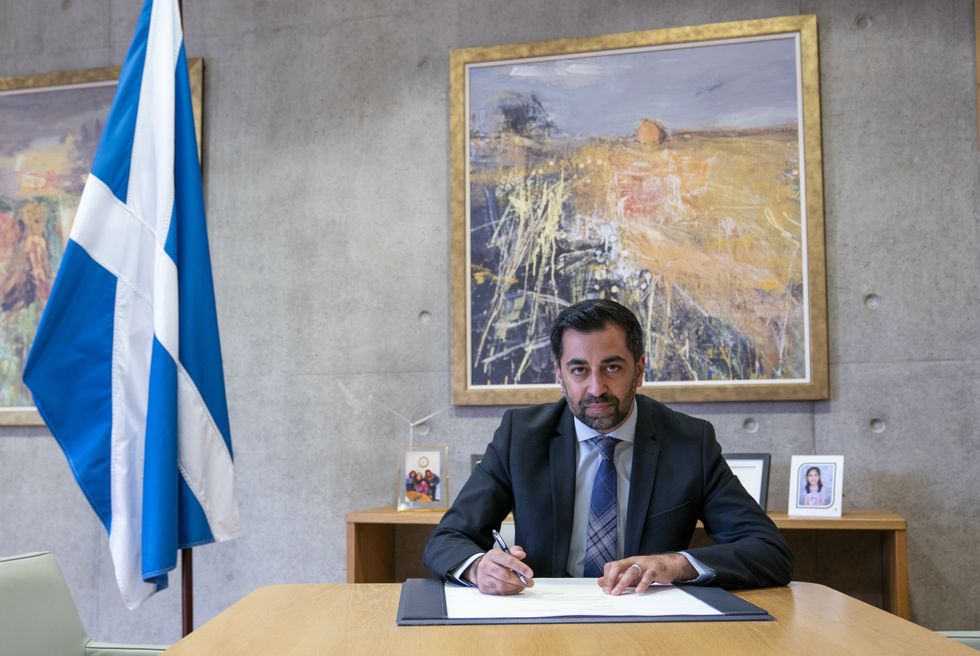 Humza Yousaf signs his official resignation letter to King Charles III at the Scottish Parliament in Edinburgh