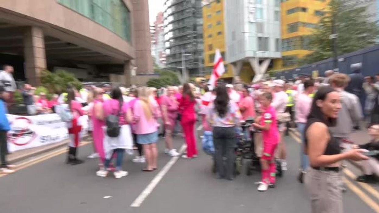 Migrant arrested on suspicion of common assault after 'bursting into blind woman's flat' near asylum hotel he was staying in