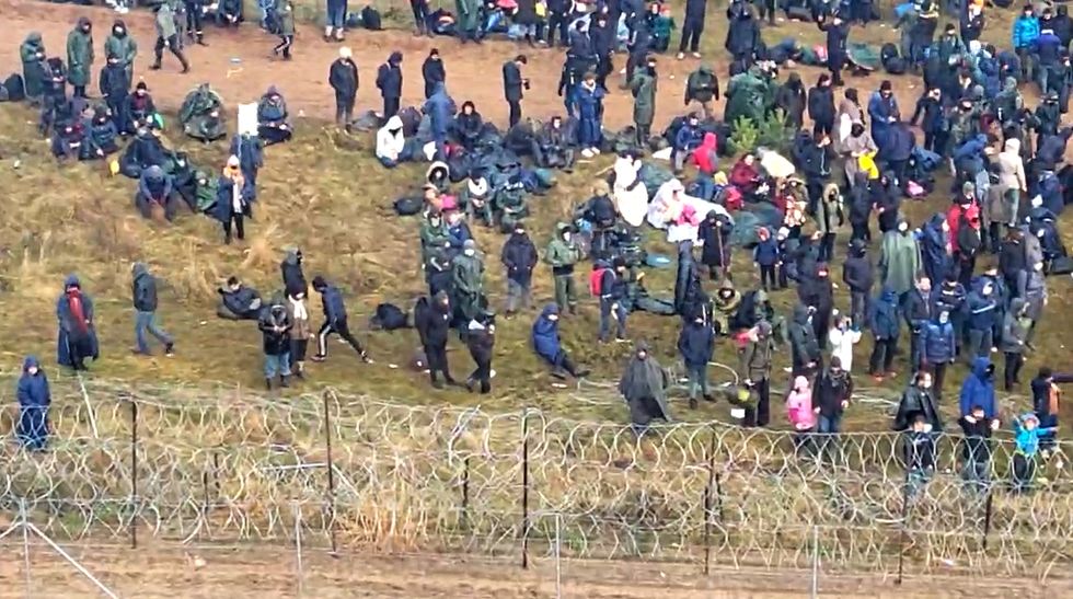 Hundreds of migrants try to cross from the Belarus side of the border with Poland near Kuznica Bialostocka, Poland, in this video-grab released by the Polish Defence Ministry, November 8, 2021.