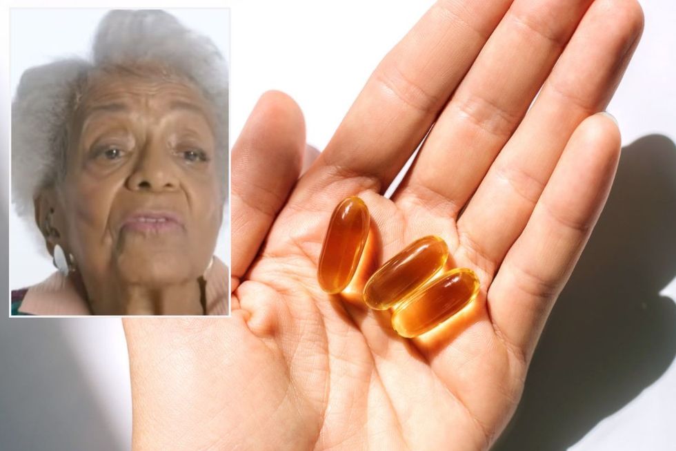 Ida Keeling / Hand holding fish oil supplements
