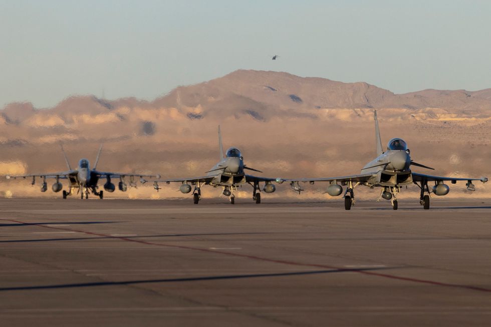 Image shows Typhoons from 2 (AC) Squadron, RAF Lossiemouth, leading in a US Navy EA-18G Growler after a successful mission at Nellis Air Force Base during Red Flag 23-1. A Royal Air Force detachment, operating from Nellis Air Base Nevada, is honing its cutting-edge air combat skills in the largest scale Exercise Red Flag to date.Exercise Red Flag is the pre-eminent annual air combat training exercise run by the United States. The United States Air Force has expanded this long-established exercise to include a vastly increased geographical area to challenge participants to overcome what USAF planners are calling the Tyranny of Distance in addition to the traditional combat air missions of previous exercises.The Exercise has previously been run over the Nevada Test and Training Range and area of 12,000 square miles of airspace and 2.9 million acres of land. Now training areas in Utah and California have been added, as well as missions being flow out over the Californian Pacific Coast. The exercise area has therefore become vast and is aimed to reflect the challenges of conducting air operations at range The RAF detachment of around 300 personnel currently taking part on the exercise is operating seven Typhoons from RAF Lossiemouth based II (Army Co-operation) Squadron, plus a Voyager operated from 10 and 101 Squadron based at RAF Brize Norton. In addition, aircrew from 51 Squadron based at RAF Waddington have been integrated into the flight crew of a USAF RC-135 Rivet Joint intelligence gathering aircraft. Australia is the only other nation participating, reflecting the close Defence partnership between our three countries.