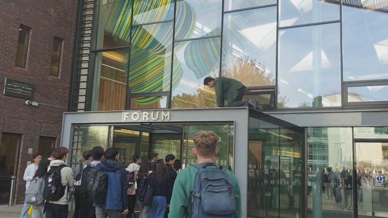 WATCH: Just Stop Oil protester throws paint over university building as students laugh