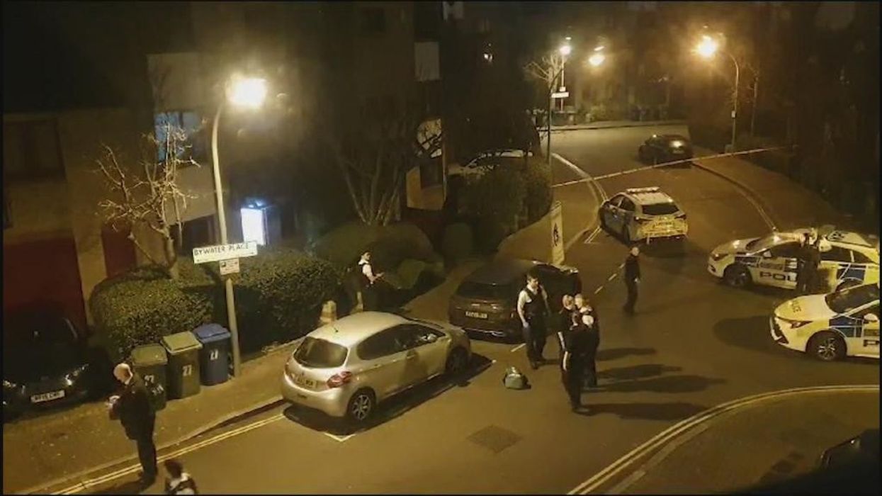 GB News footage shows police swarming on London property before shooting man armed with crossbow