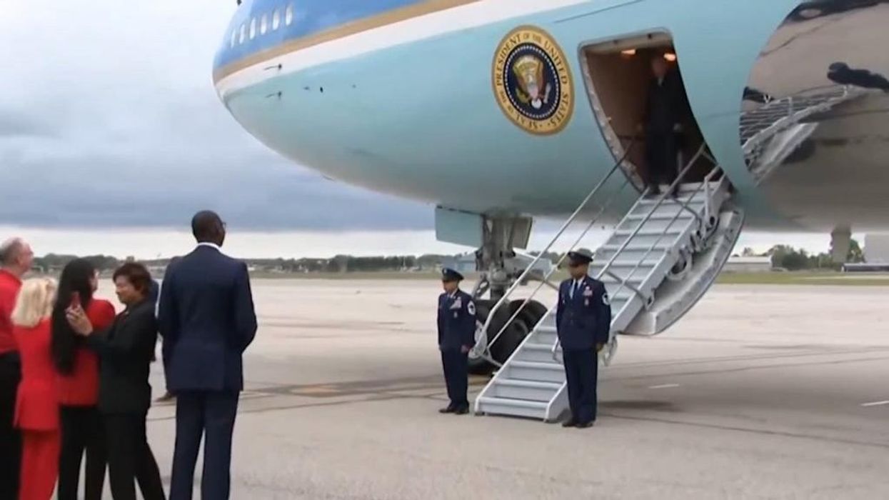 Joe Biden nearly stumbles off plane in Michigan