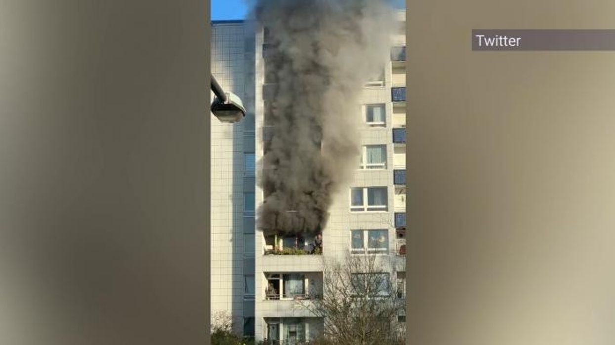 Terrifying moment man jumps from burning building after explosion in block of flats in Germany