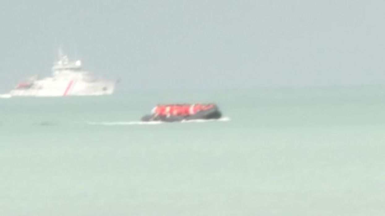 WATCH: Moment French police struggle to stop DOZENS of migrants crossing the Channel after being outnumbered