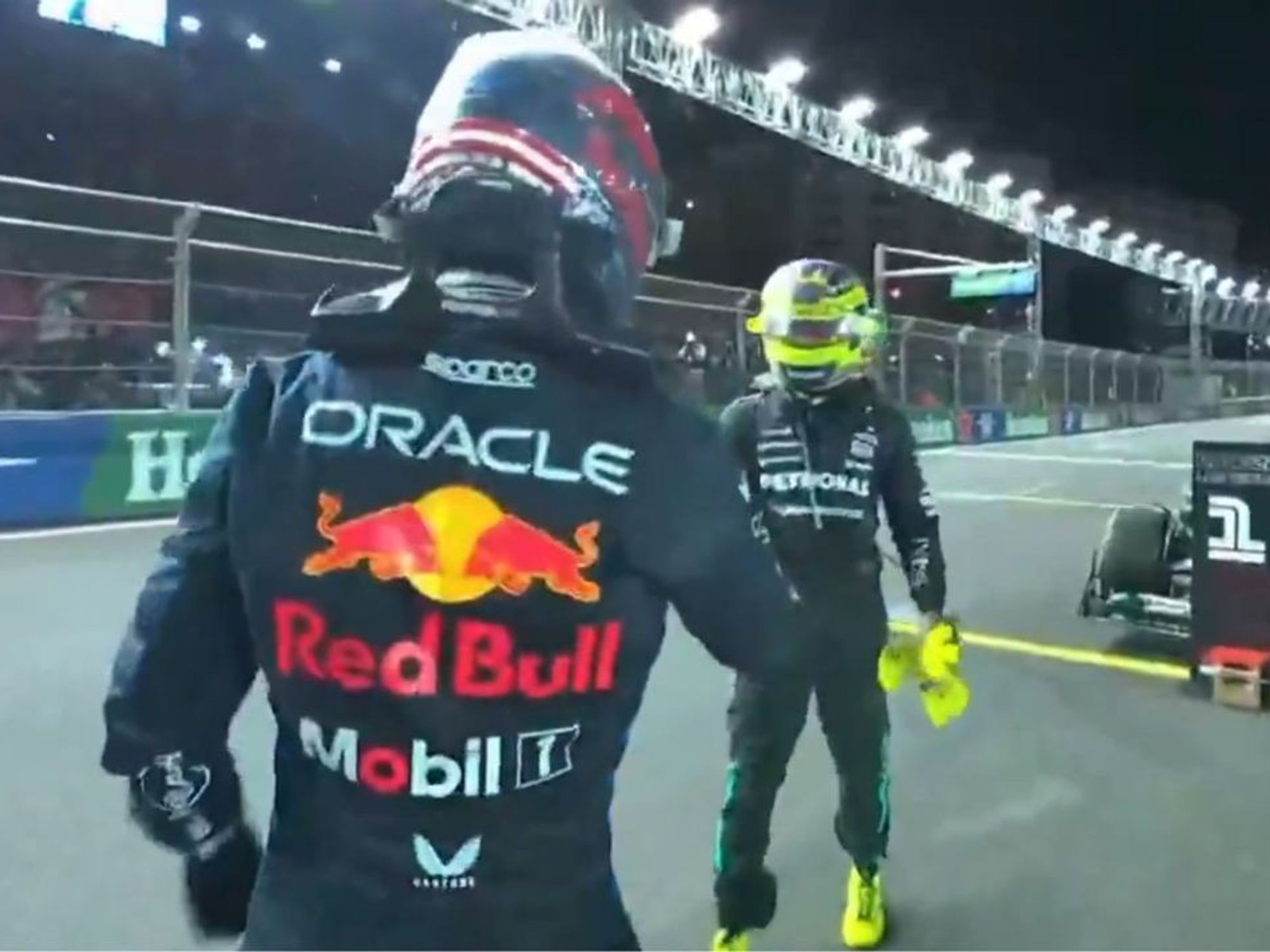 Lewis Hamilton gesture to Max Verstappen immediately after Red Bull star's fourth world title spe...