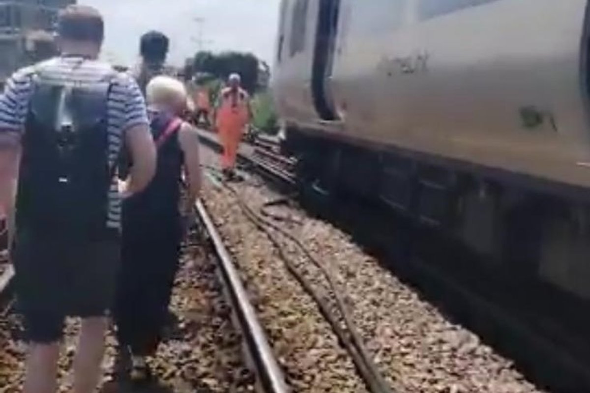 London train evacuated: Hundreds of passengers walk along tracks as 33C 'heat hell' sparks travel chaos