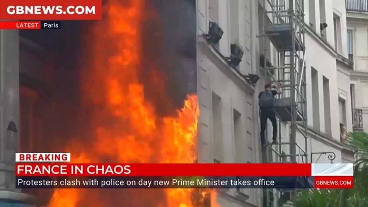WATCH: French protesters set fire to a restaurant in Paris after government collapse