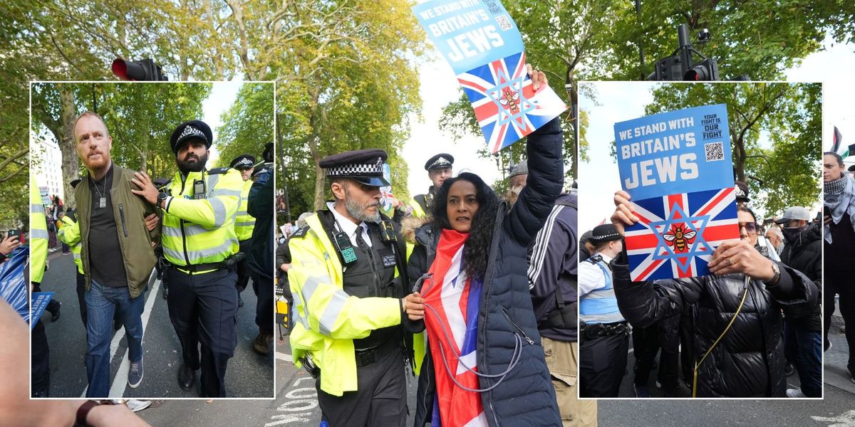 NextImg:Police remove people carrying placards saying 'we stand with Britain's Jews' as pro-Palestine protesters shout 'shame'