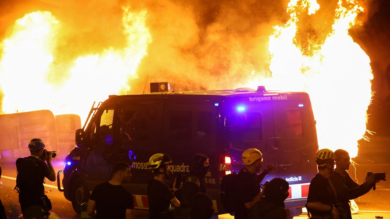 Pro-Palestine mobs trash Spain tourist hotspot as police cars burn and violent clashes erupt