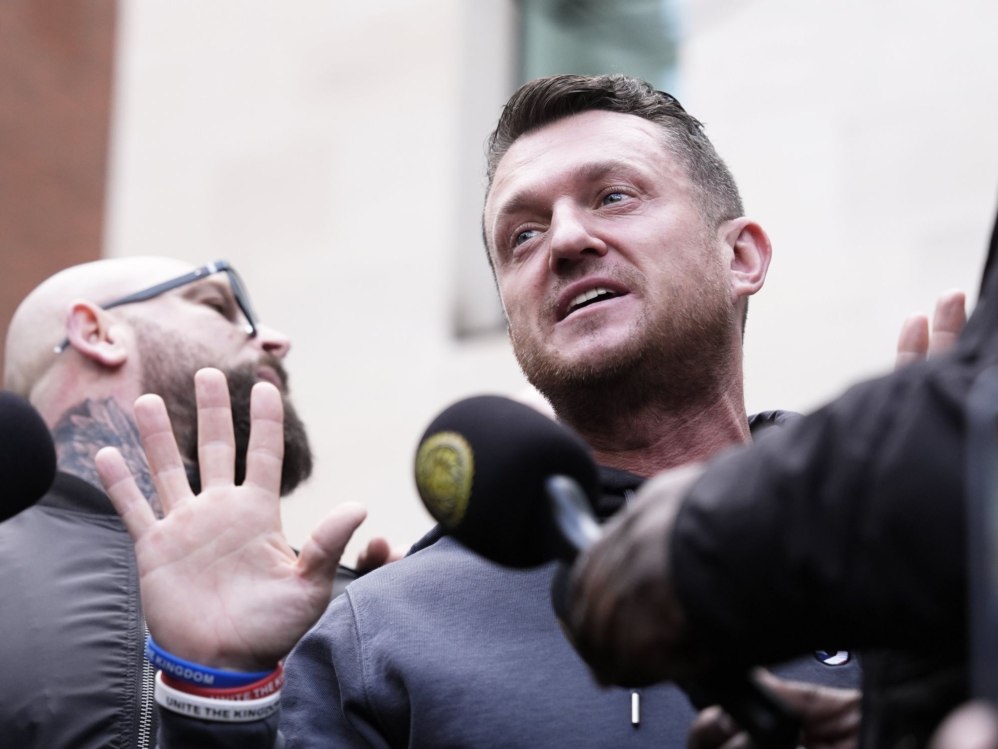 Tommy Robinson cleared of terror charge after failing to provide police with mobile phone pin