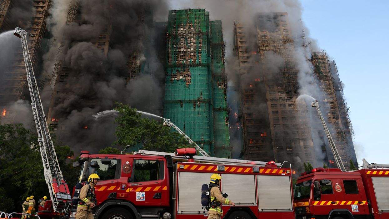 At least four people dead after huge fire engulfs three apartment blocks leaving residents trapped in terrifying scenes