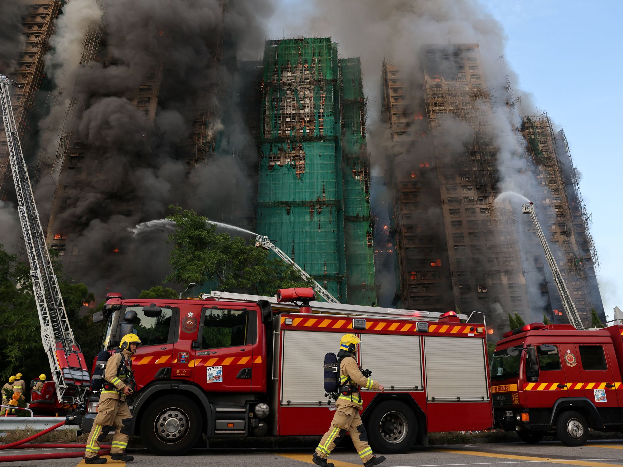 At least four people dead after huge fire engulfs three apartment blocks leaving residents trappe...