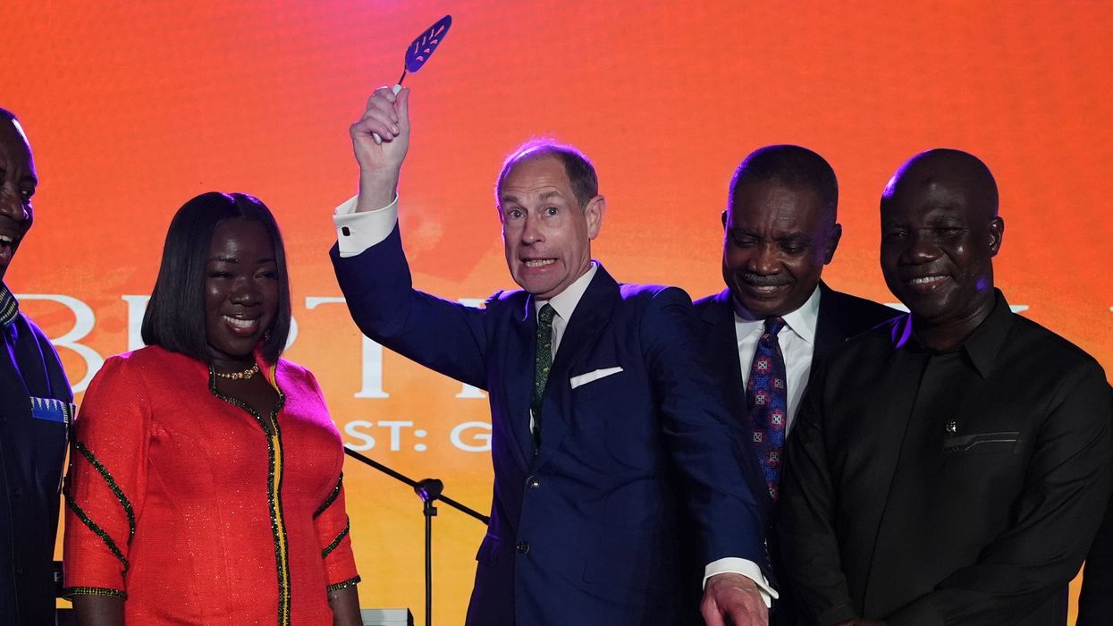 Prince Edward waves knife above his head in flamboyant cake cutting ceremony