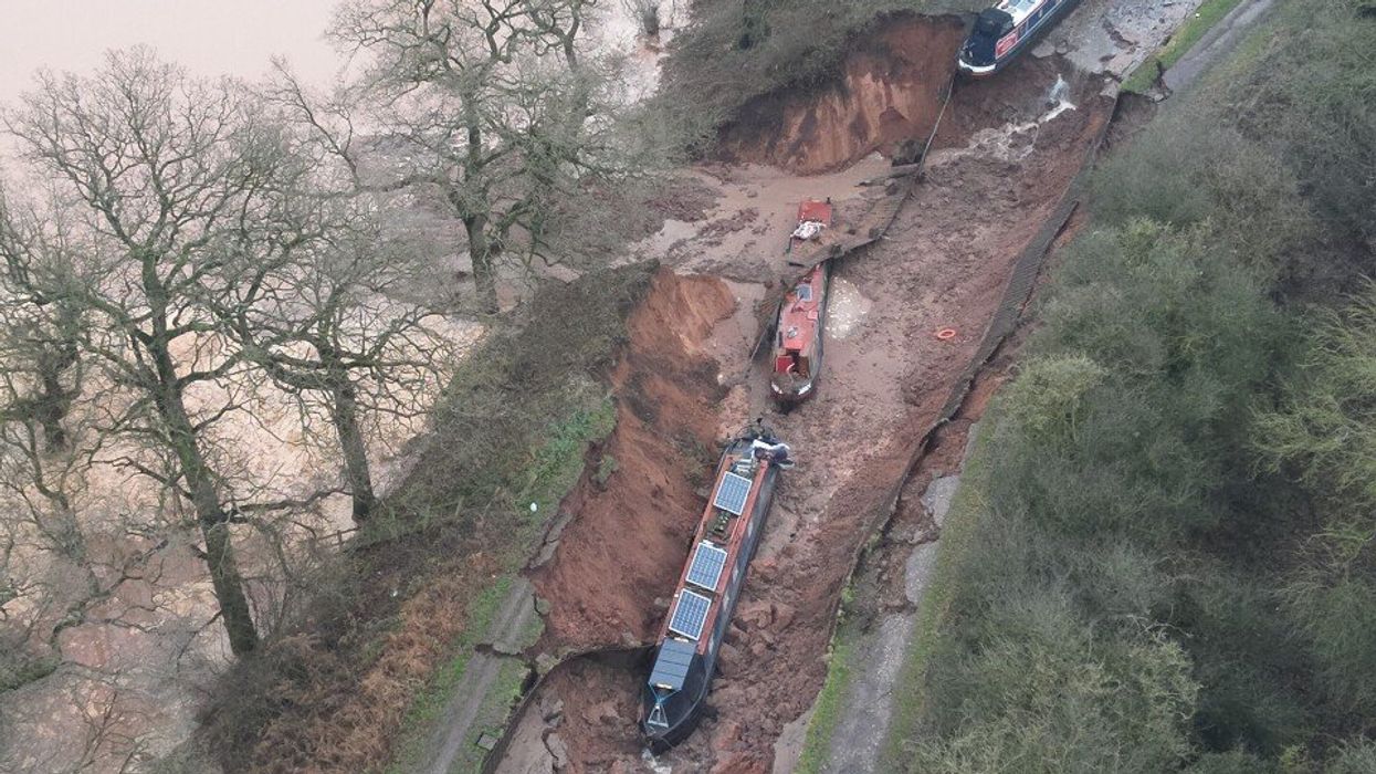 PICTURED: Three boats stranded and 10 people rescued after being swallowed by 50-metre sinkhole