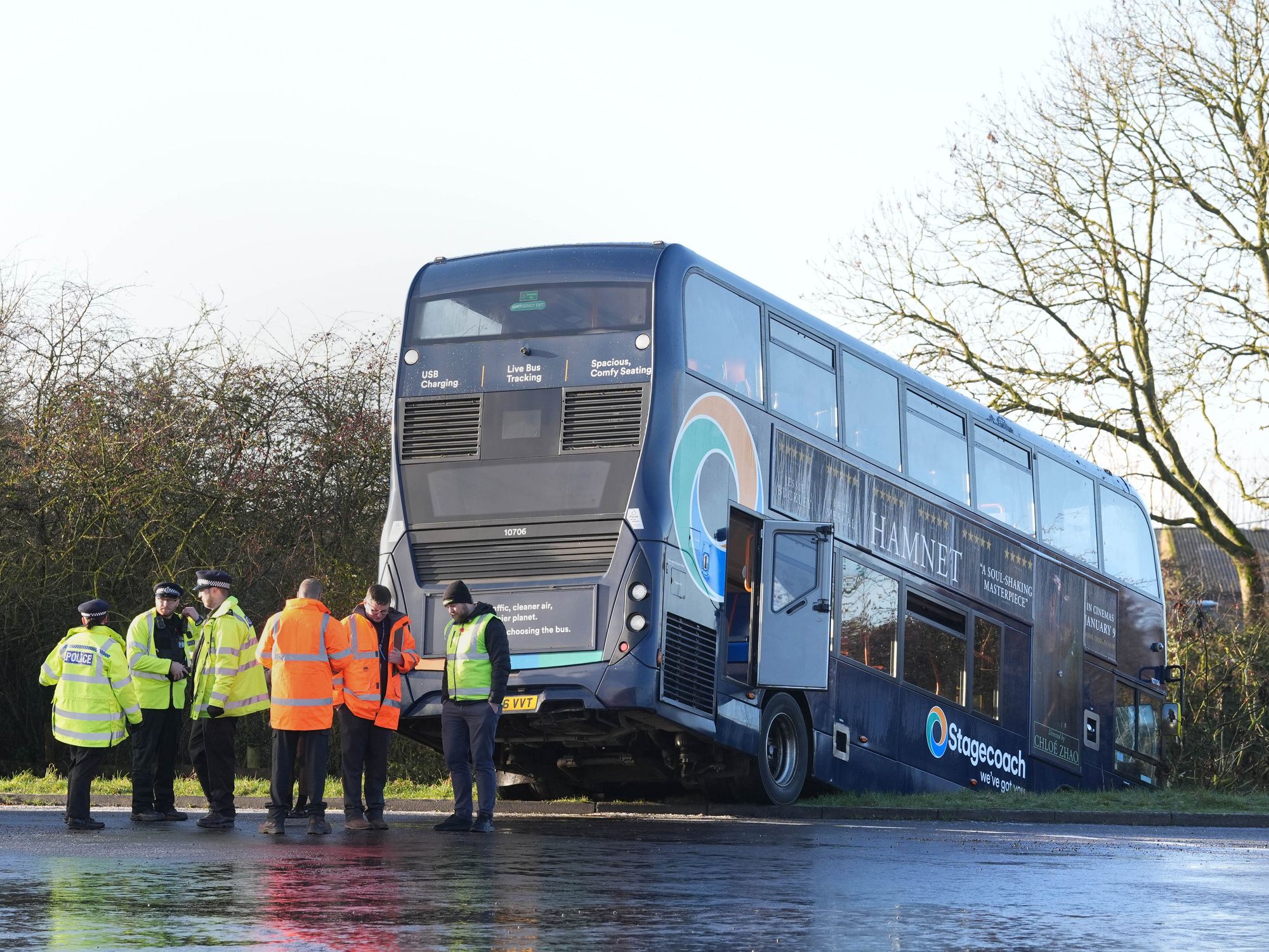 School bus full of children crashes into ditch after slipping on black ice as emergency services ...