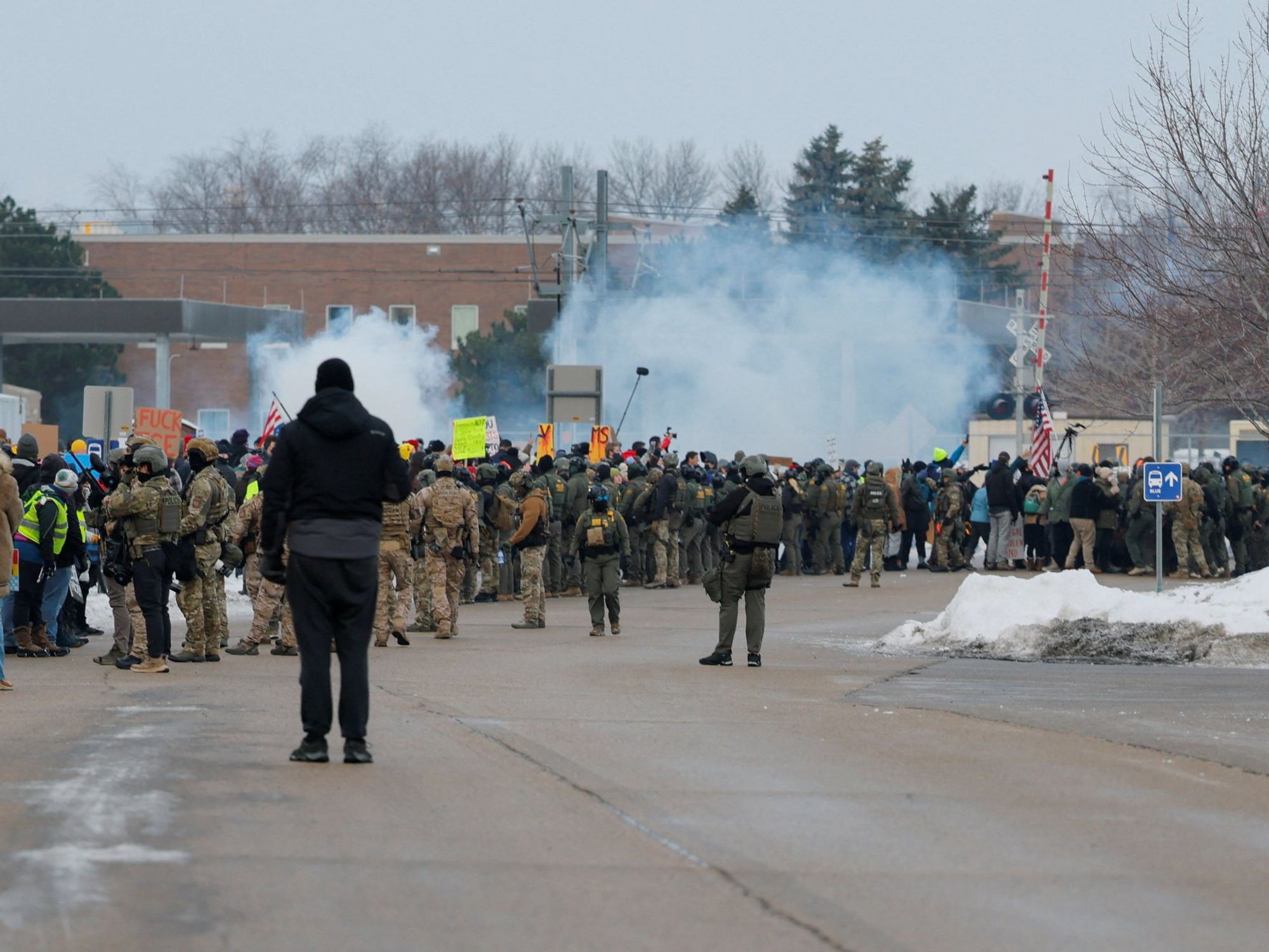 Protesters clash with riot police in Minneapolis after woman shot in head by Ice agent
