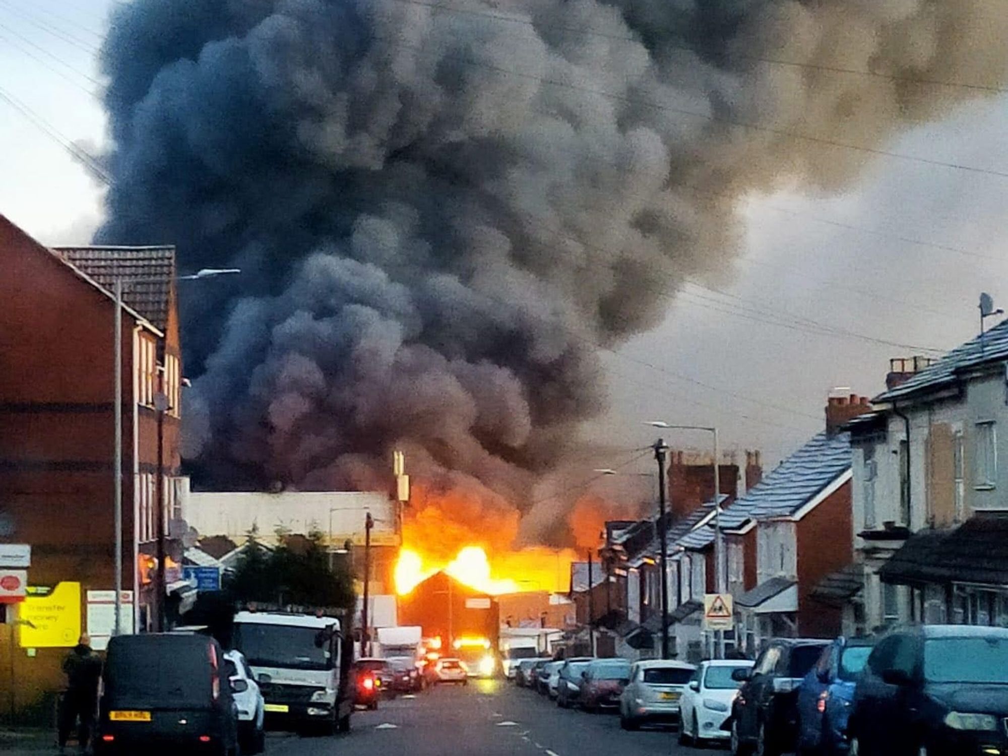 Huge inferno sends smoke billowing over city after 'explosions' heard