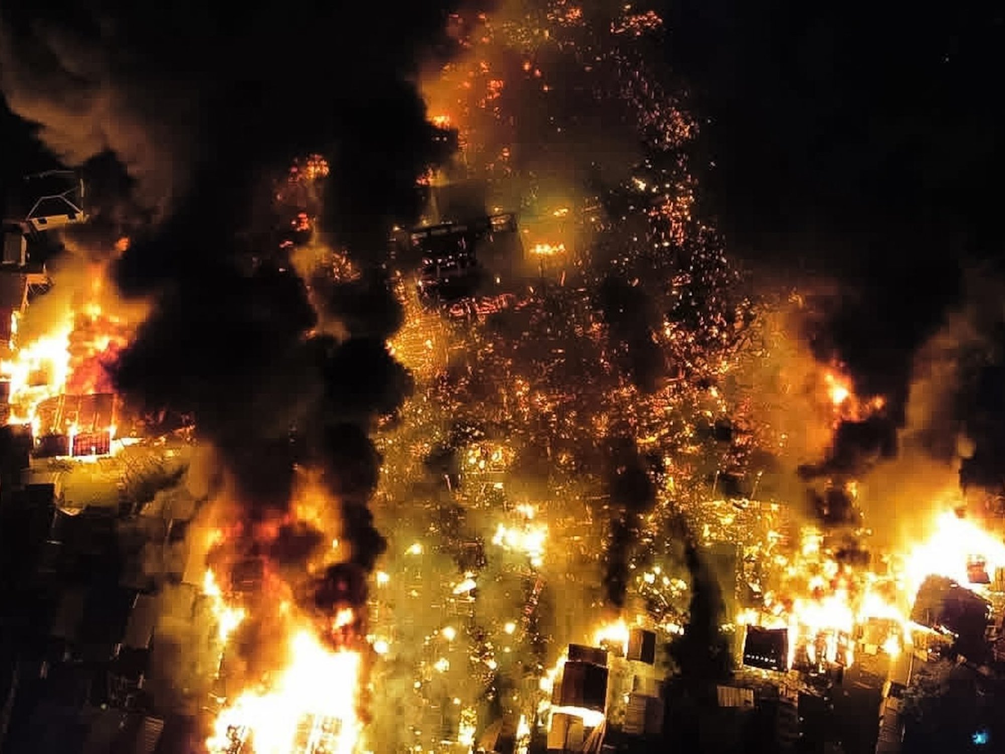 PICTURED: Huge inferno reduces village to ruins as orange flames and billows of smoke soar into n...