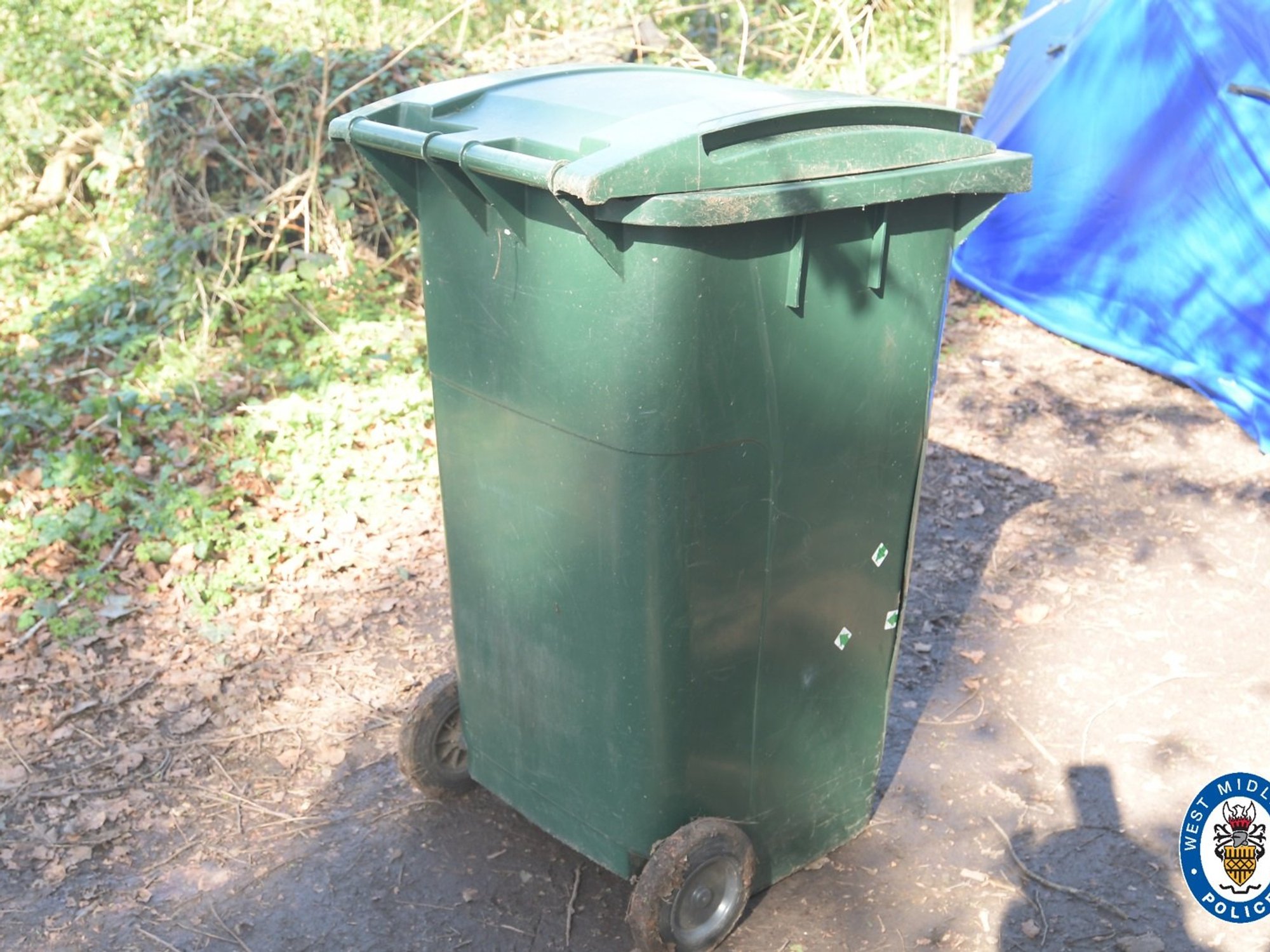 Three arrested after man's body found in green wheelie bin
